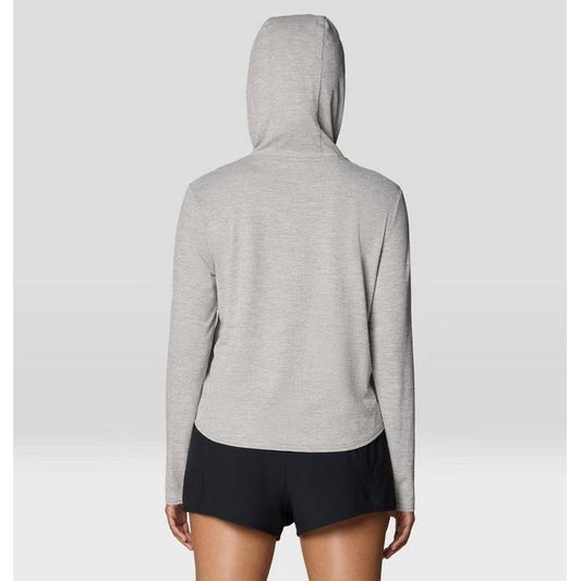 Back view of the Mountain Hardwear Women's Sunblocker Long Sleeve Hoody in Half Moon Grey on a model wearing black shorts against a light background.