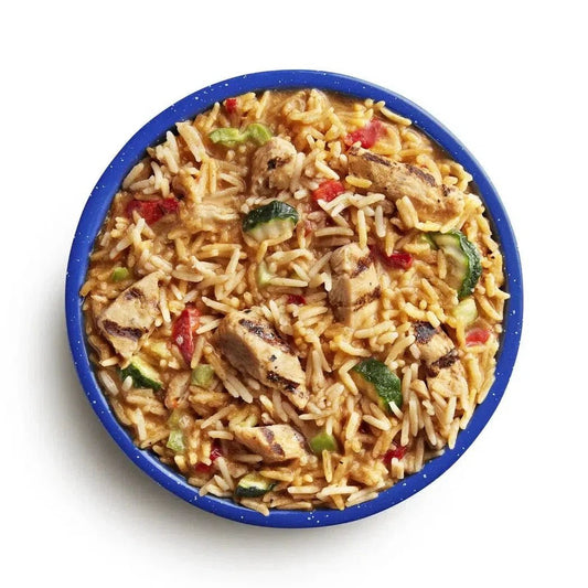 A top-down view of the Mountain House Kung Pao Chicken (GF) in a blue bowl with visible chicken, rice, and vegetables.