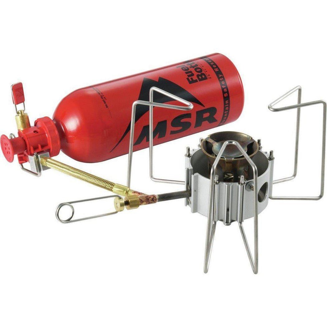 A red MSR DragonFly Stove with a fuel bottle and metal stand against a white background.