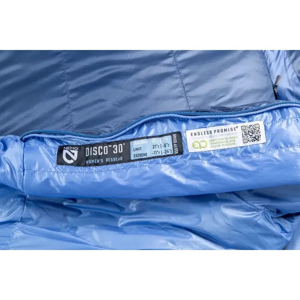 Close up of the NEMO Disco 30 Women's sleeping bag in Blue Horizon showing the zipper and labels.