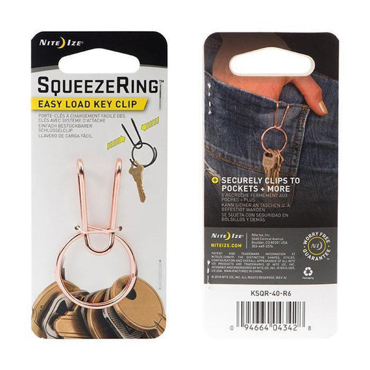 Back of Nite Ize SqueezeRing Easy Load Key Clip showing it clips to pockets with a hand in jeans.