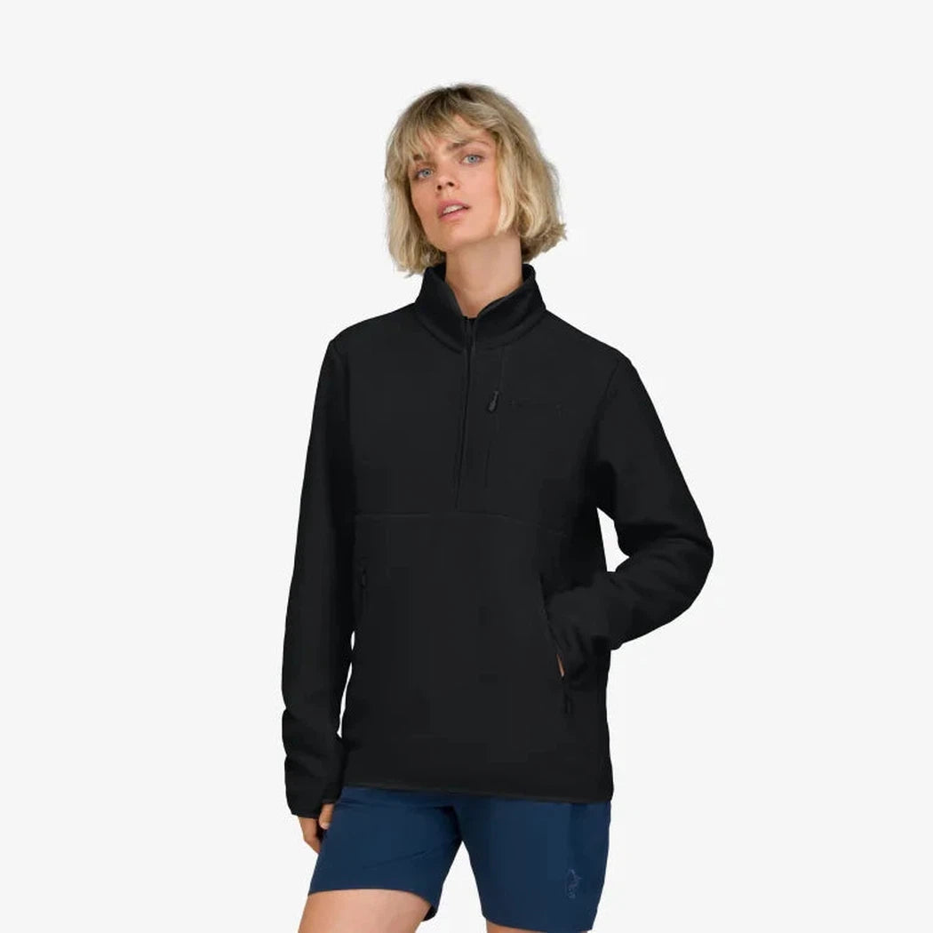 A front view of the Norrona Unisex Femund Warm 2 Halfzip in Caviar Black on a model wearing blue shorts against a white background.
