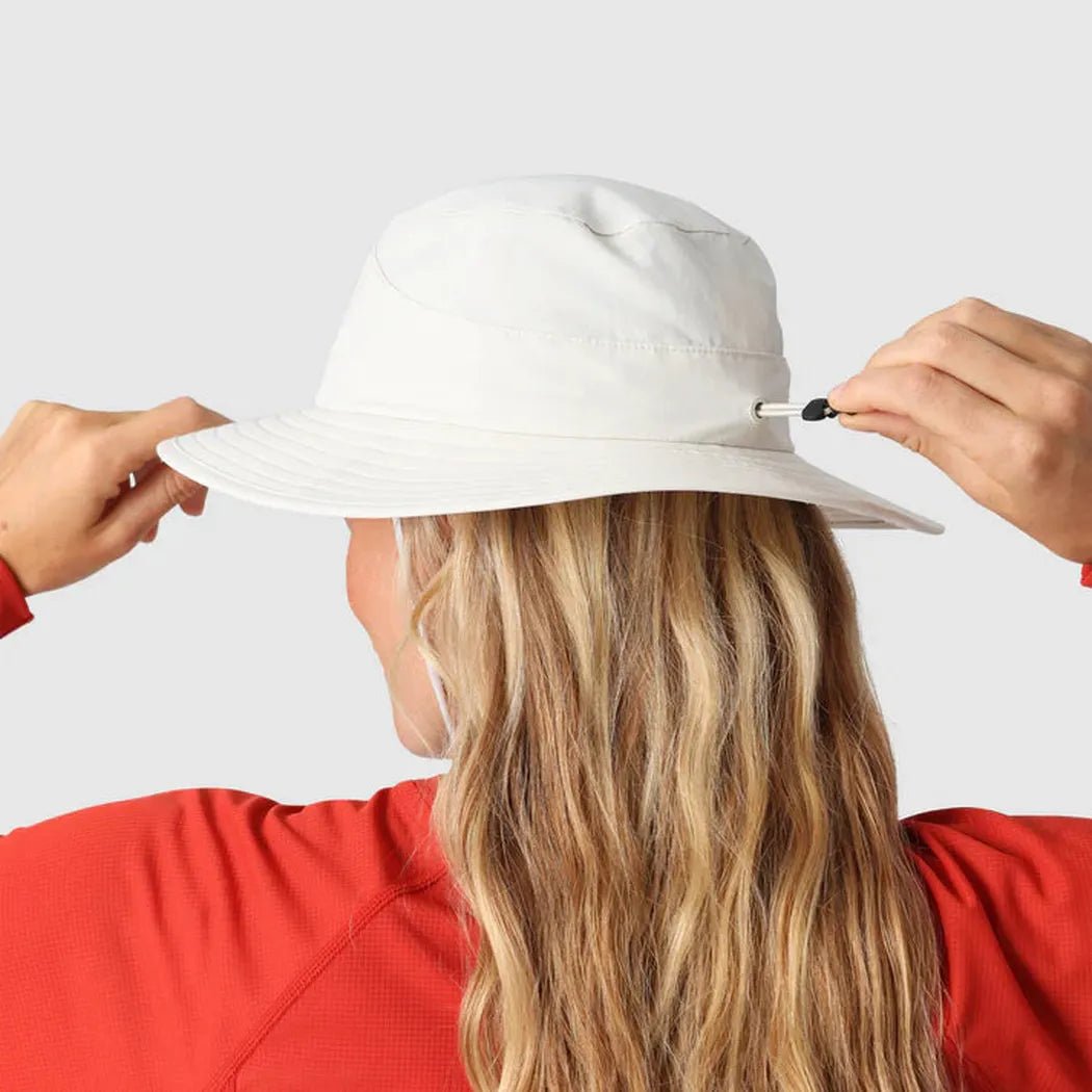 Back view of the Outdoor Research Helios Sun Hat in Light Pewter on a model with long blonde hair against a plain white background.