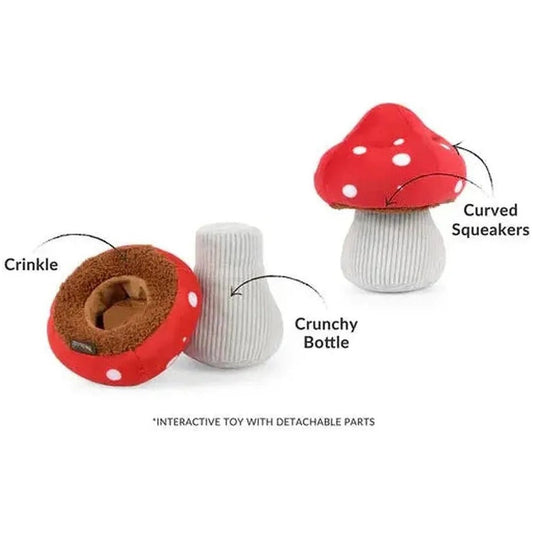 A photo of the P.L.A.Y Blooming Buddies Mutt's Mushroom pet toy showing its red and white mushroom top, brown crinkle interior, and white crunchy bottle base against a white background.