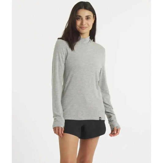 A model wearing the Paka Apparel Women's Sol Hoodie in Heather Grey stands against a plain white background.