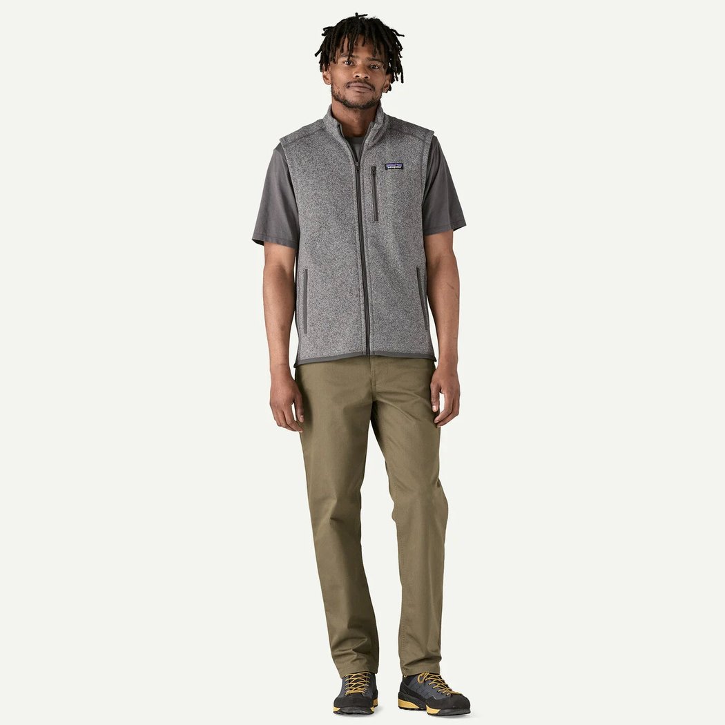 A model wearing the Patagonia Men's Better Sweater Vest in Charcoal/Graphite stands against a plain white background.