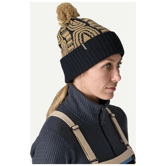 Side view of the Patagonia Powder Town Beanie in Flow: Sunken Blue on a model wearing a dark blue sweater.