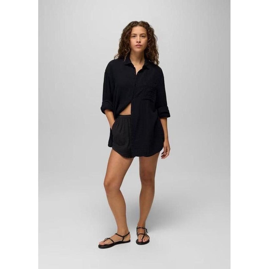 A model wearing the Prana Women's Hideaways Button Down Top in Black stands against a light gray background.