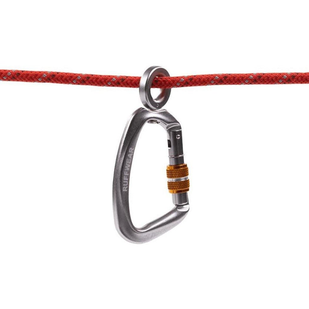 A red rope with a silver Ruffwear Knot-a-hitch carabiner hanging from it against a white background.