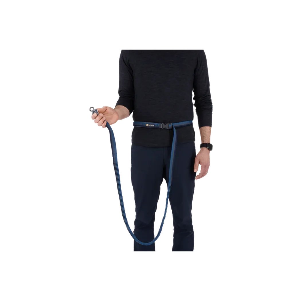 A person wearing a black top and dark pants holds the Ruffwear Roamer Leash in Orion Blue against a white background.