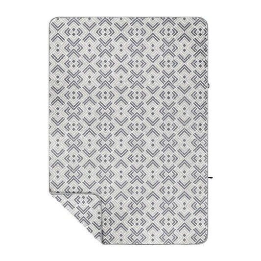 A flat lay of the Rumpl Sherpa Fleece in Kaleidoscope Stone showing the geometric pattern and folded corner.