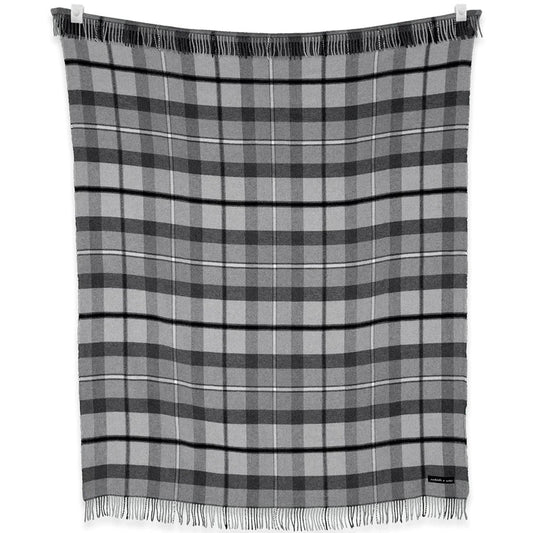 A charcoal and graphite plaid blanket from the Sackcloth & Ashes Folk Collection hangs on a clothesline with fringes visible.