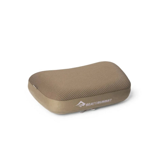 A side view of the Sea To Summit Aeros Premium Pillow in Burnt Olive showing the textured surface against a white background.