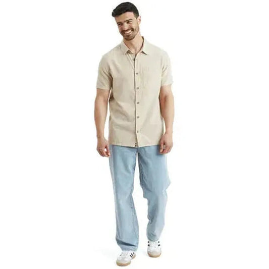 A front view of the Sherpa Adventure Gear Men's Daha Short Sleeve Shirt in Bardiya Sand on a model against a white background.