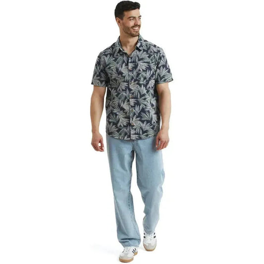 A model wears the Sherpa Adventure Gear Men's Havai Short Sleeve Shirt in Rathee Blue against a white background.