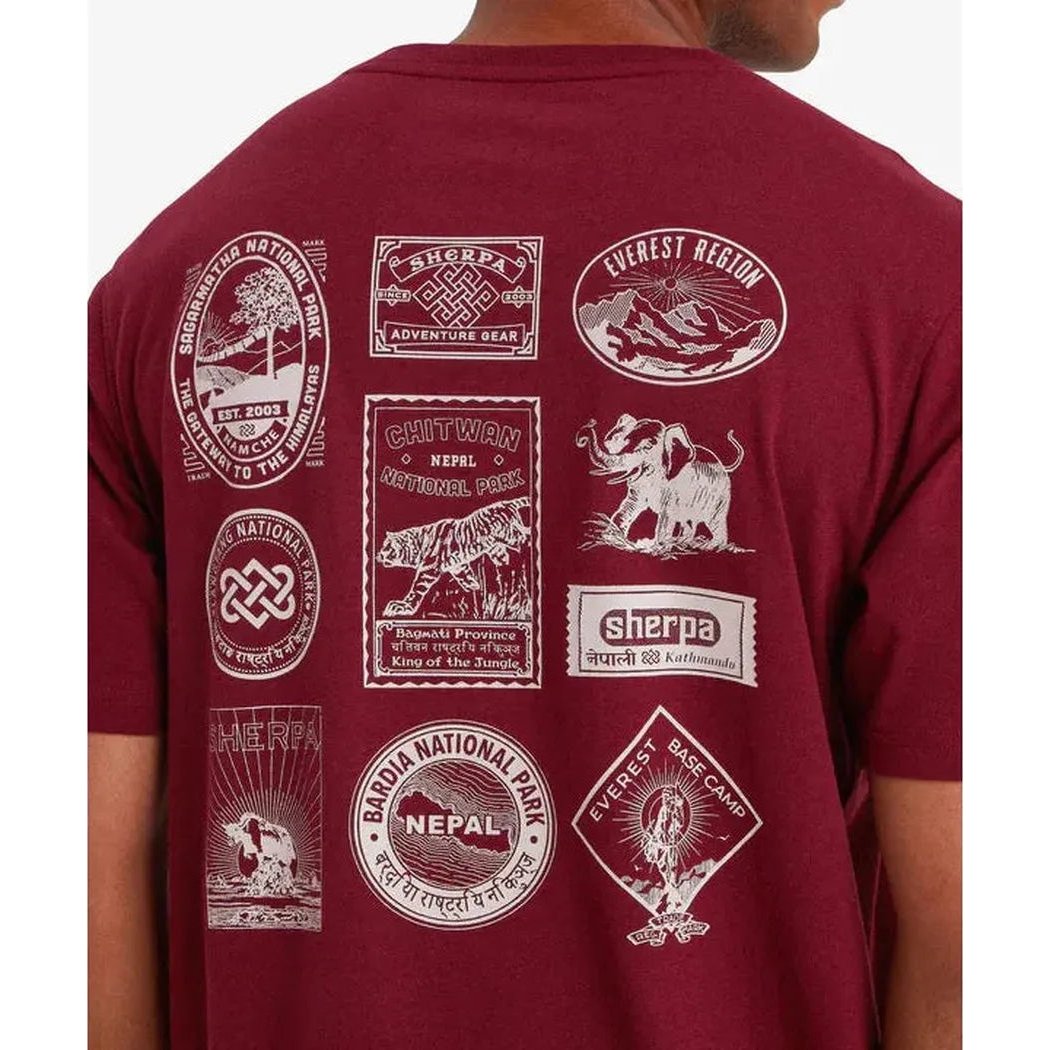 Back view of the Sherpa Adventure Gear Men's Jutnu Badge Tee in Wine showing multiple badge designs on the back.