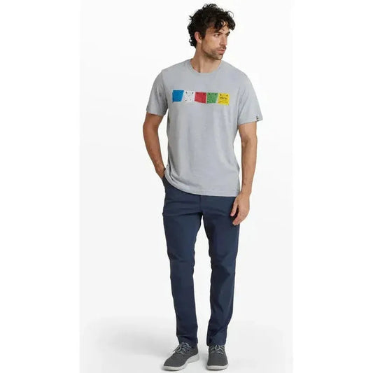 A man wearing the Sherpa Adventure Gear Sample - Men's Tarcho Tee in Heather Grey stands against a white background.