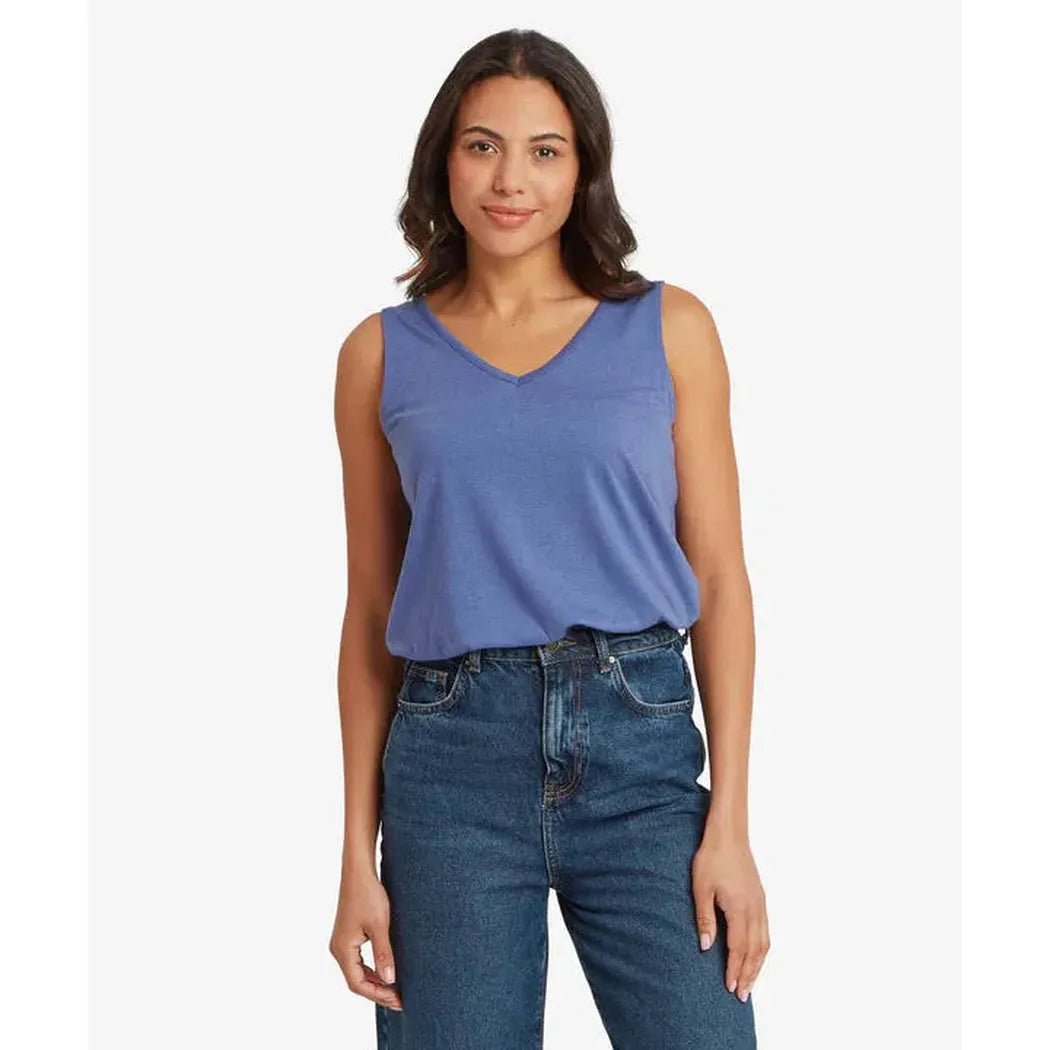 A front view of the Sherpa Adventure Gear Women's Bali V-Neck Tank in Peetho on a model wearing blue jeans against a plain white background.
