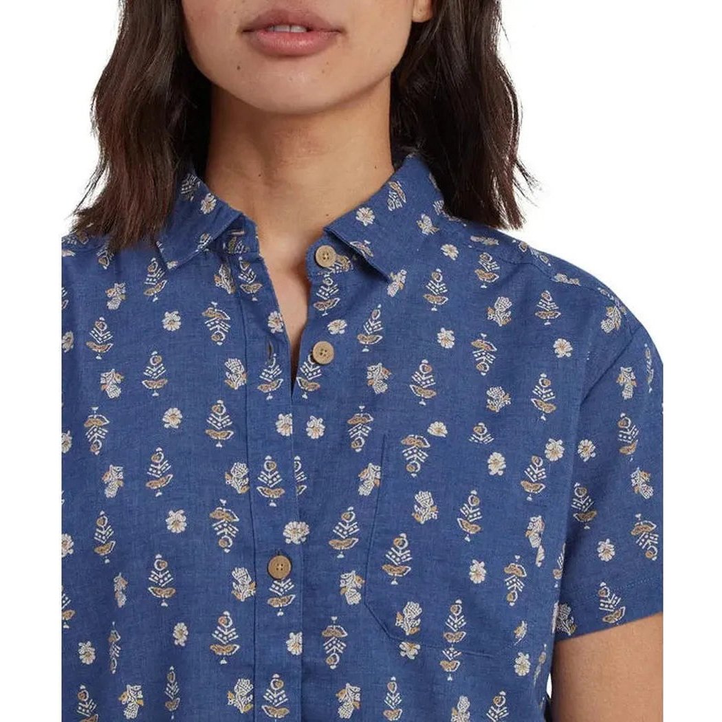A close-up of the Sherpa Adventure Gear Women's Jaya Camp Shirt in Seaport Blue Indi Blossom, showing the button-down collar and floral pattern on a model against a white background.