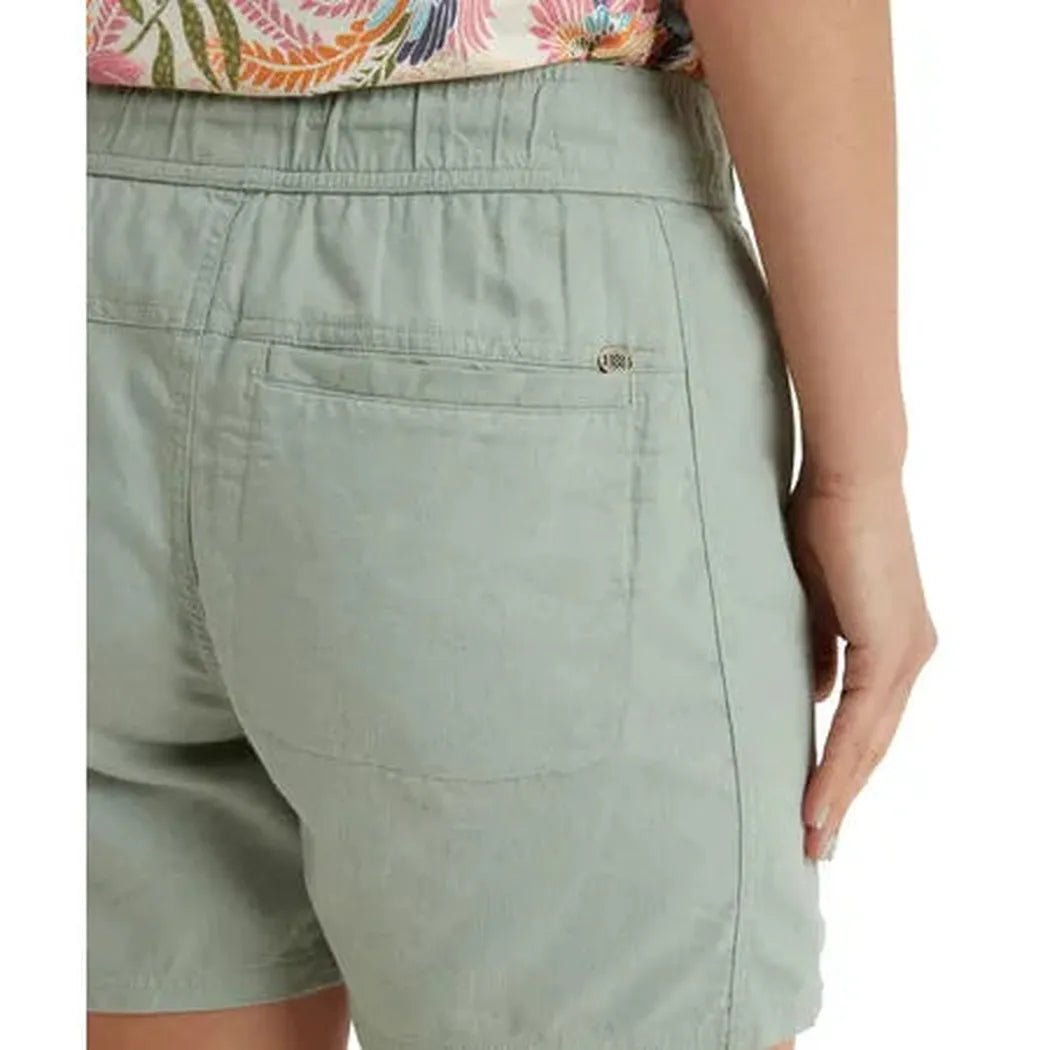 Back view of the Sherpa Adventure Gear Women's Palmo Short in Celery showing the back pocket and elastic waistband.