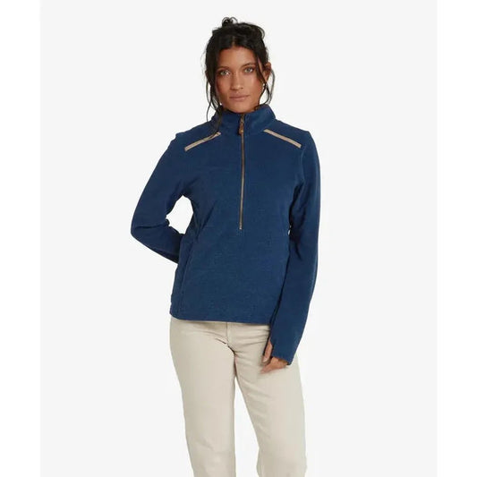 A woman wearing the Sherpa Adventure Gear Women's Rolpa Eco Pullover Zip in Rathee Blue stands against a plain white background.
