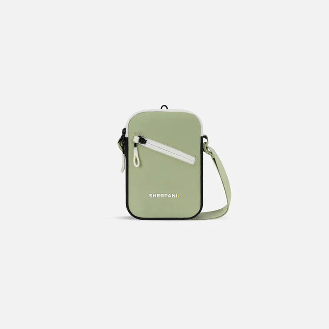 A front view of the Sherpani Rogue bag in Chromatic with a shoulder strap and zip pocket against a white background.