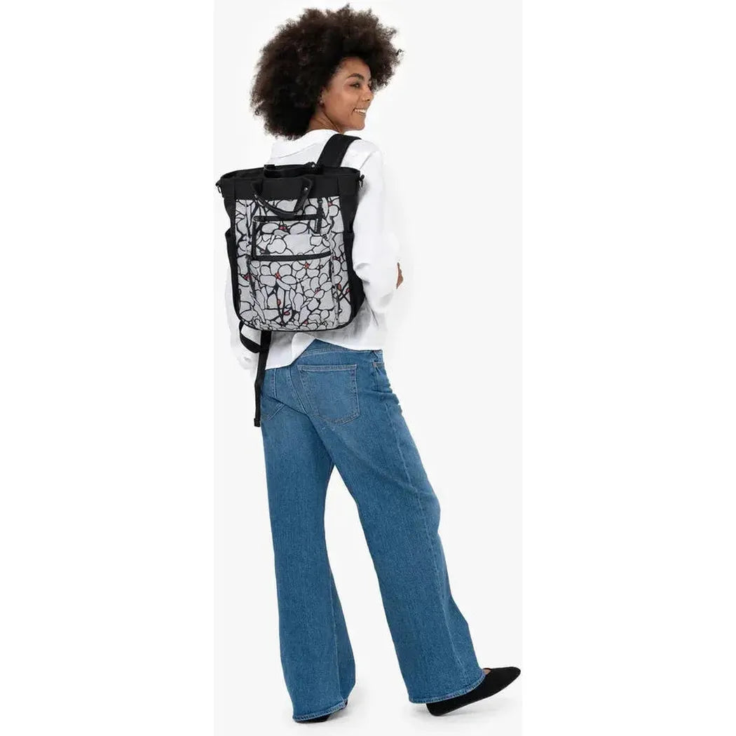 Back view of the Sherpani Soleil AT backpack in Aloe Mist on a model wearing blue jeans against a white background.