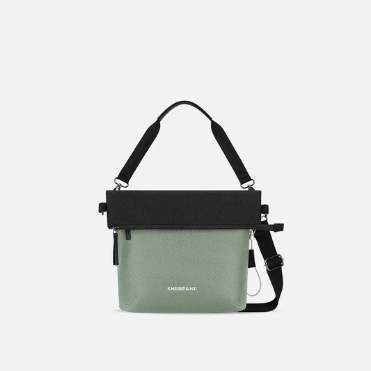 A front view of the Sherpani Vale AT bag in Aloe Mist with a black top flap and adjustable strap against a white background.