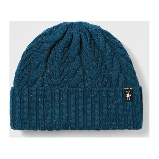 A front view of the Smartwool Cable Knit Beanie in Natural with a black logo tag on the cuff against a light gray background.