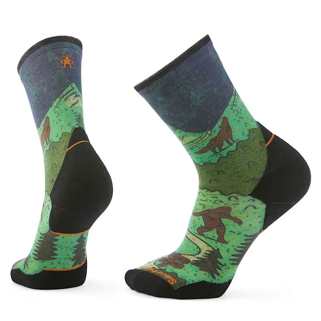 Two views of the Smartwool Trail Run Targeted Cushion Neature Print Crew Socks in Twilight Blue showing the forest scene design and black heel and toe.