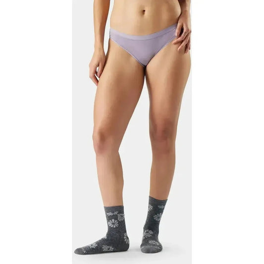 A front view of the Smartwool Women's Everyday Merino Bikini Boxed in Black on a model wearing patterned socks against a white background.
