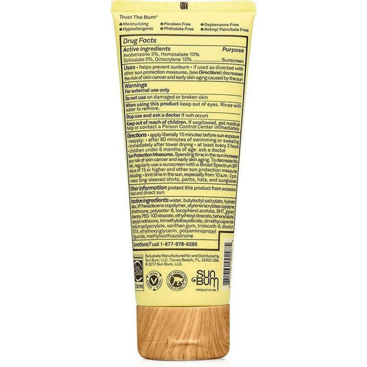 Back view of Sun Bum SPF 50 Clear Face Sunscreen Lotion showing the drug facts label and wooden cap against a white background.