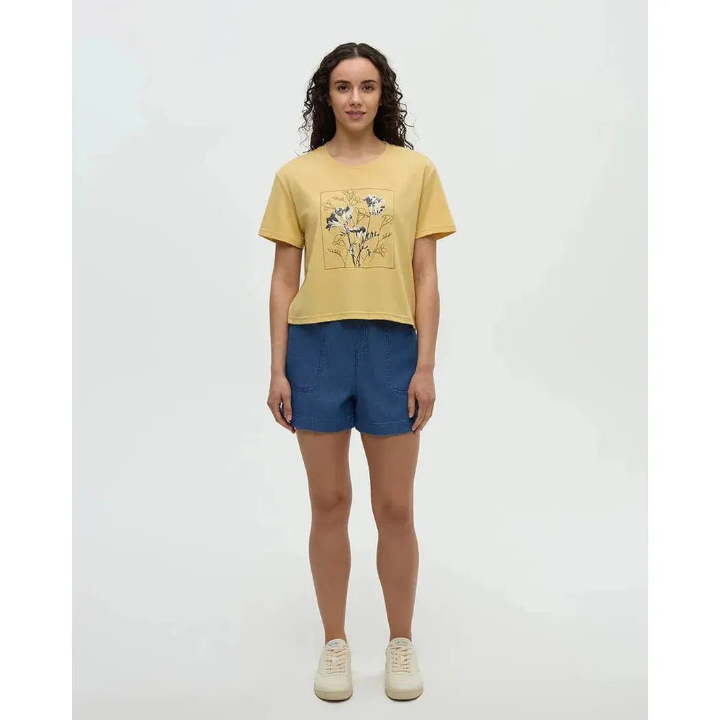 A model wearing the Tentree Women's Floral Crop T-Shirt in Dusk Yellow Meteorite Black stands against a plain white background.