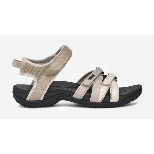 Side view of the Teva Women's Tirra in Black/Grey showing the adjustable straps and black outsole against a white background.