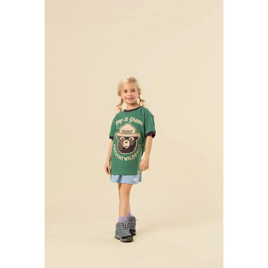 A front view of The Landmark Project Keep It Green Youth Short Sleeve Ringer Tee in Palm Leaf/Dusk on a model against a neutral background.