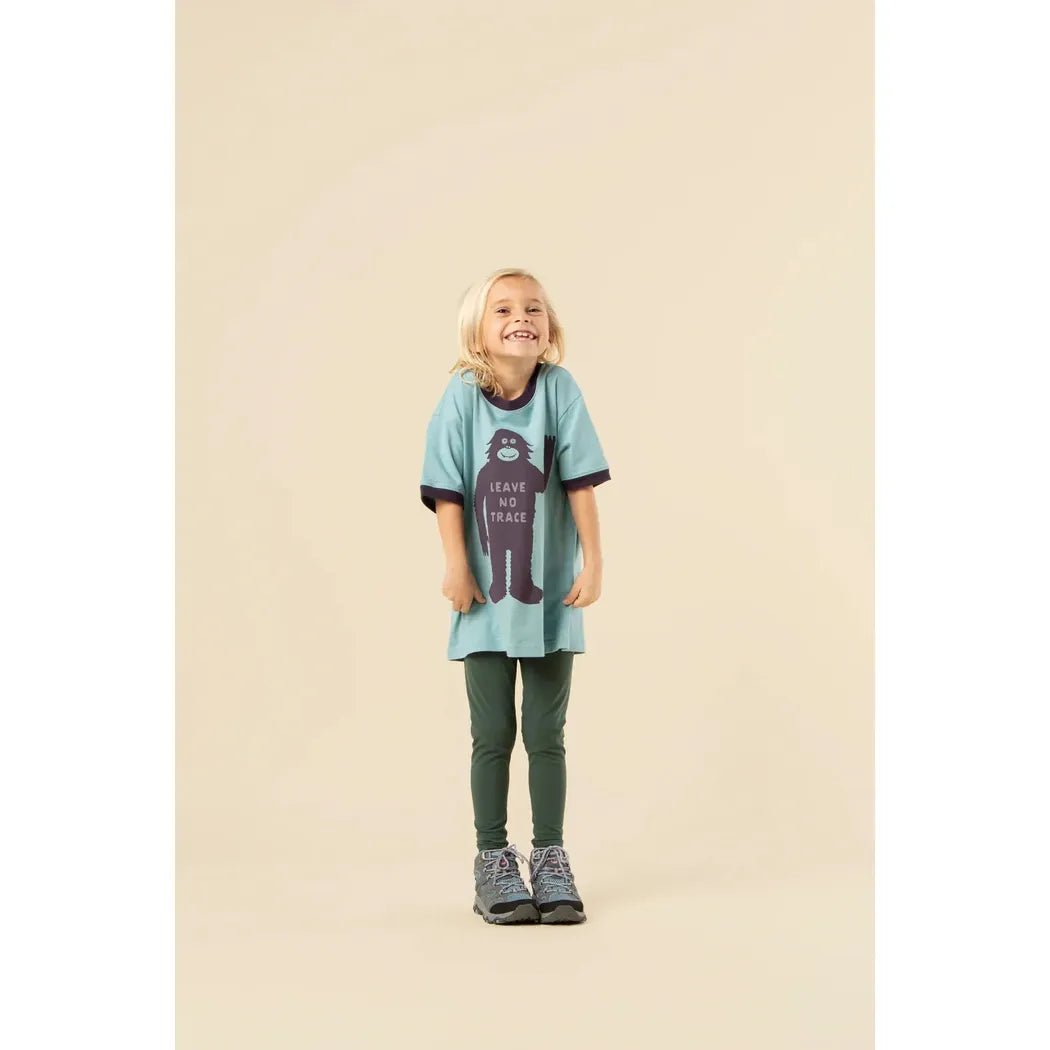 A young girl wears the Glacier Blue/Dusk The Landmark Project Leave No Trace Youth Short Sleeve Ringer Tee against a plain background.
