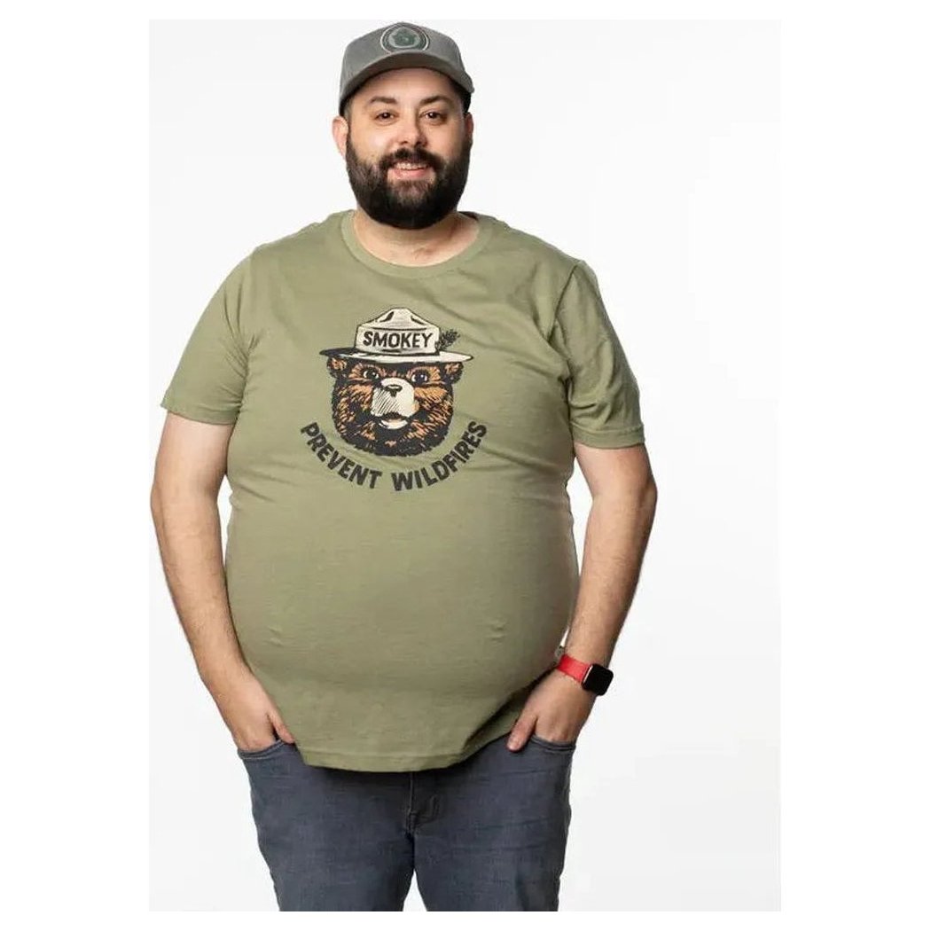A front view of a plus-size model wearing The Landmark Project Smokey Retro Unisex Short Sleeve Tee in Cactus against a white background.