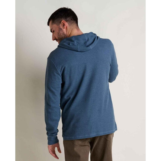 Back view of the Toad & Co Men's Framer II Long Sleeve Hoodie in Pacific Blue on a model against a plain wall.