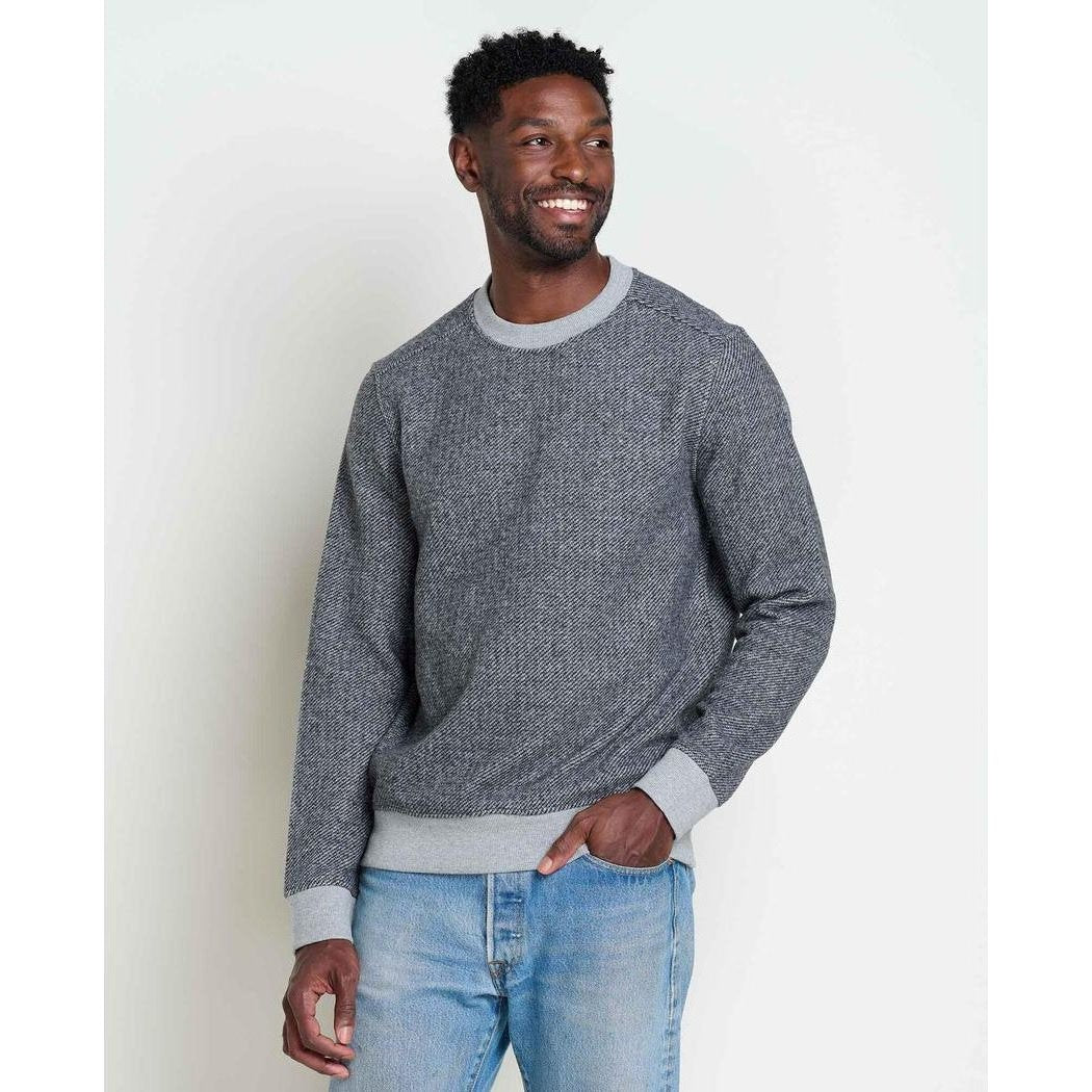A man wearing the Toad & Co Men's Kennicott Crew in Heather Grey Twill poses against a plain white background.