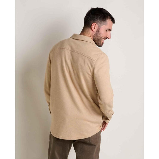 Back view of the Toad & Co Men's Shadowbrook Long Sleeve Shirt in Camel Twill on a model against a plain background.