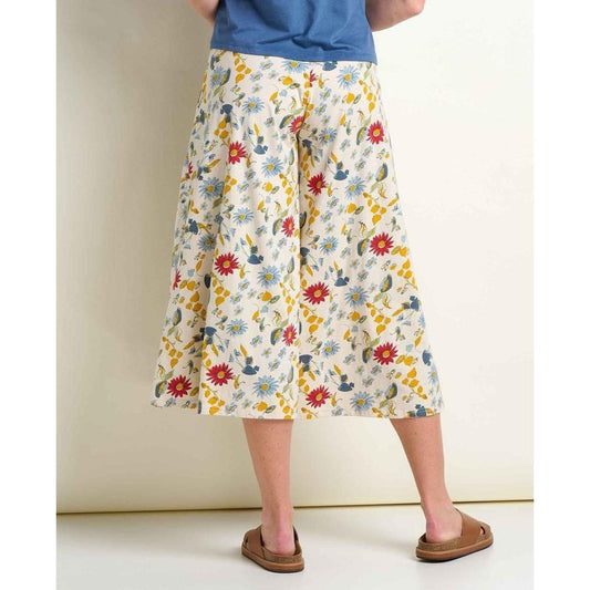 Back view of the Toad & Co Women's Chaka Culotte in Almond Print on a model wearing brown slides against a plain wall.