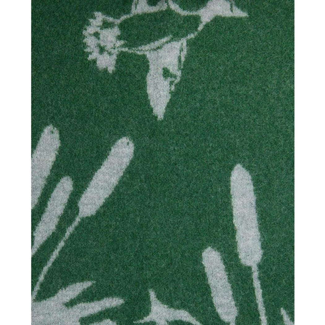 A close-up of the Toad & Co Women's Merino Heartfelt Hoodie in Coyote Ombre showing the hood and a nature-inspired print against a dark background.