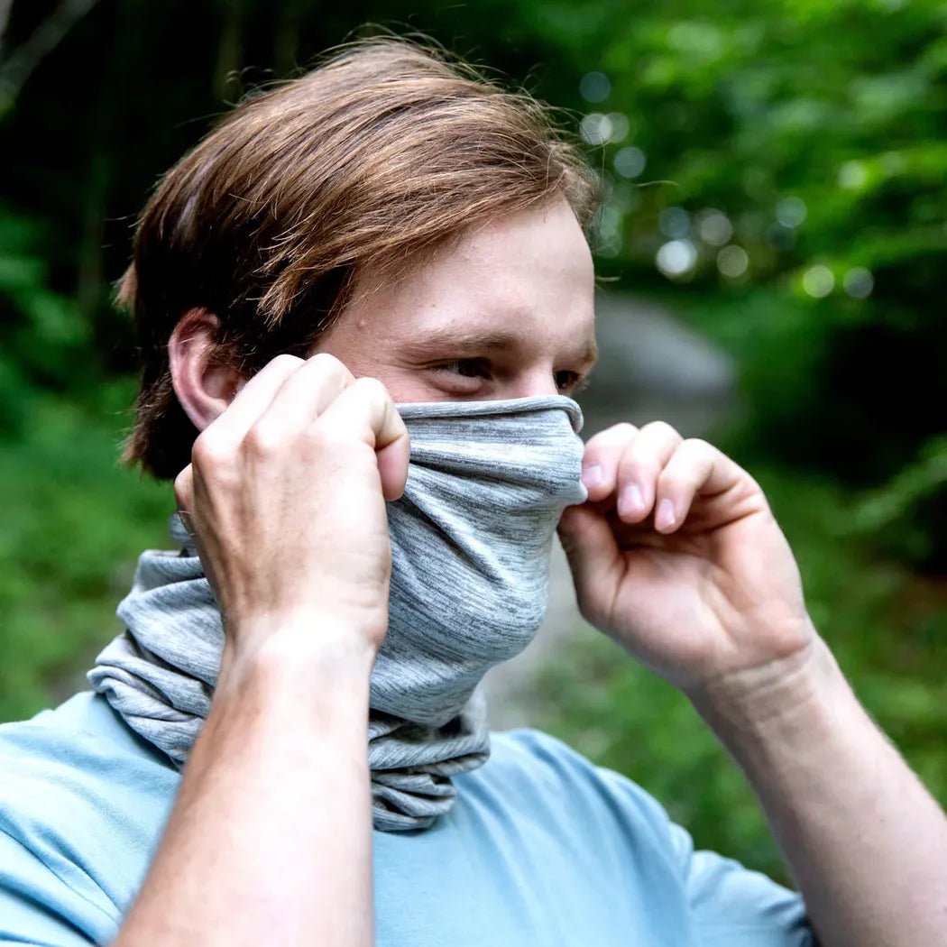A man wears the Onyx Turtle Fur Comfort Stria Tube - Stria against a green outdoor background.