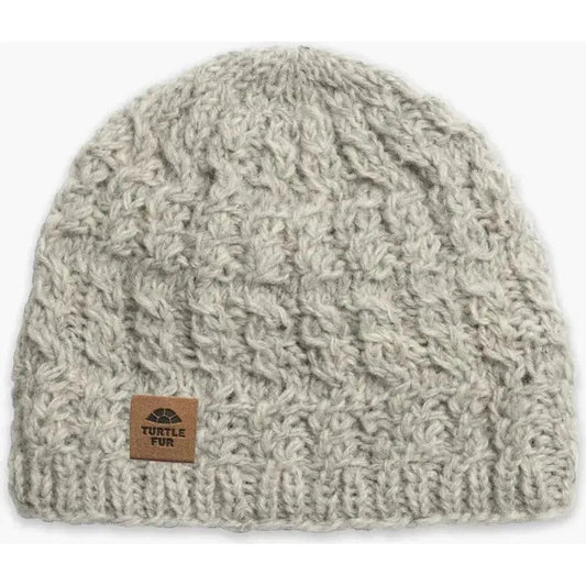 A front view of the Turtle Fur Nepal Handmade Wool Mika hat in Black with a leather tag on the front.