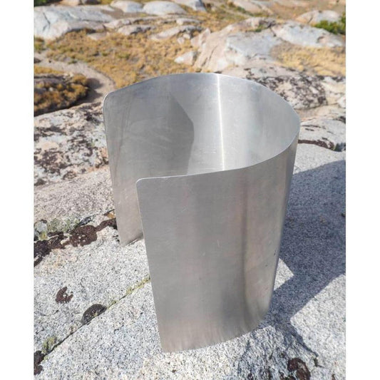 A side view of the Ursack Aluminum Liner on a rocky outdoor surface with a natural background.