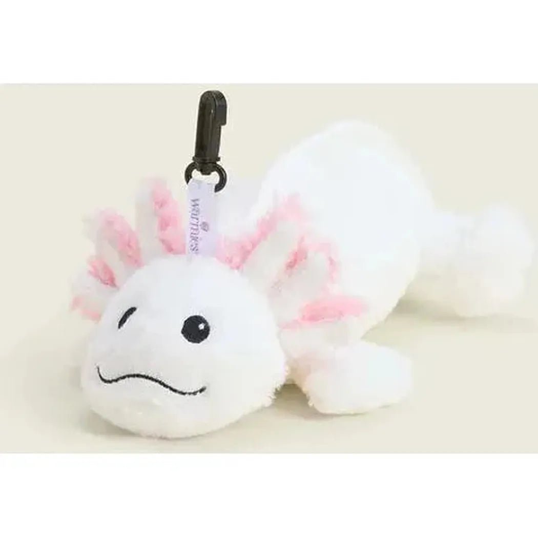 A white Warmies Axolotl Bag Charm with pink ears lies on a light background, attached to a black clip.