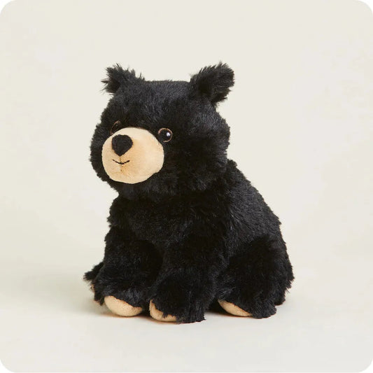 A front view of the Warmies Black Bear Junior plush toy with a light background.