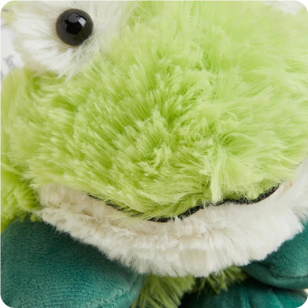 Close-up of the Warmies Frog Cozy Wraps showing the green plush texture and white trim.