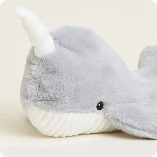 A close-up of the Warmies Narwhal plush toy showing its white tusk and black eye against a light background.
