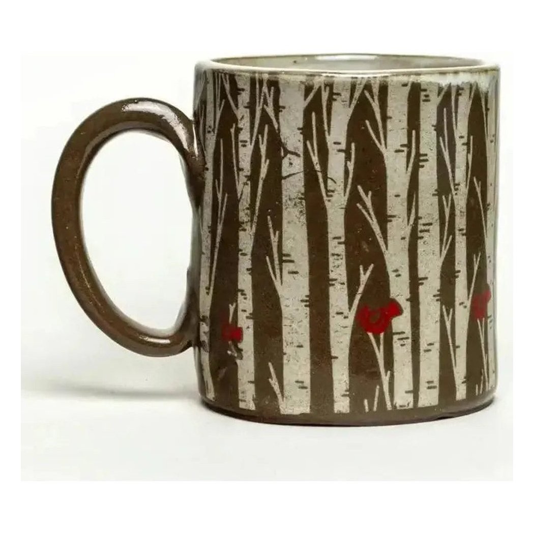 A side view of the White Squirrel Clayworks Limited Birch Trees Chocolate Clay Handmade Ceramic 12oz Mug showing the birch tree design and red accents against a white background.